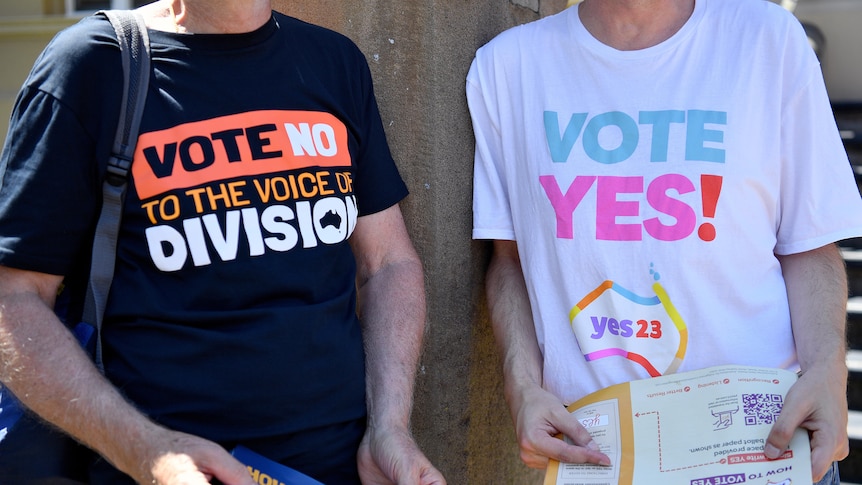Two volunteers wearing Yes and No campaign shirts stand next to each other with their faces cropped out.