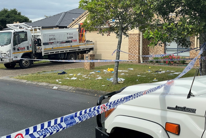 Debris on the ground behind a police cordon. 