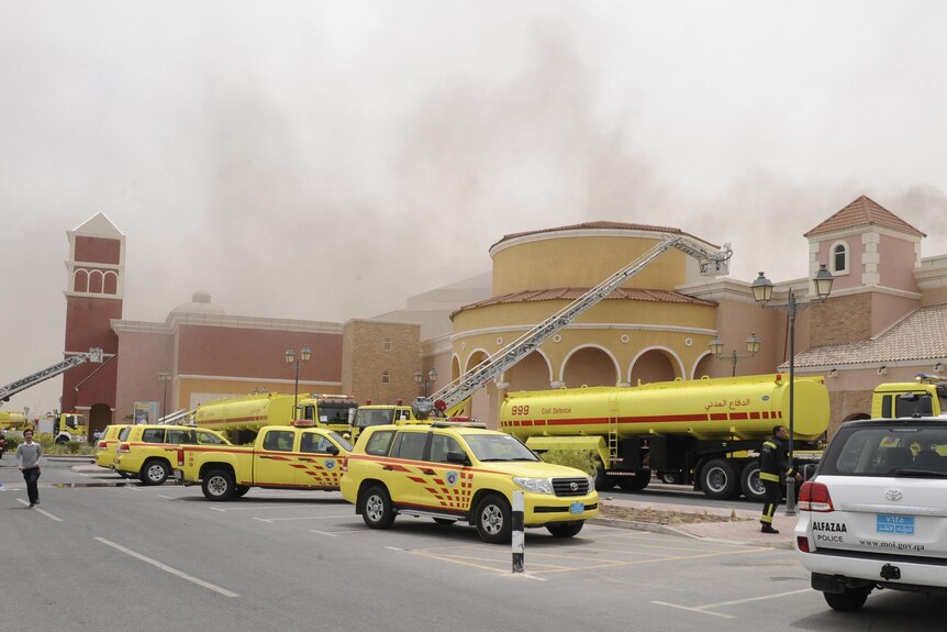 Firefighters attempt to extinguish a fire at the Villagio Mall, the main shopping centre in Doha.