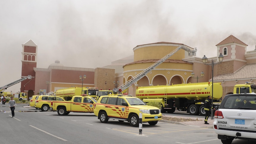 Firefighters attempt to extinguish a fire at the Villagio Mall, the main shopping centre in Doha.