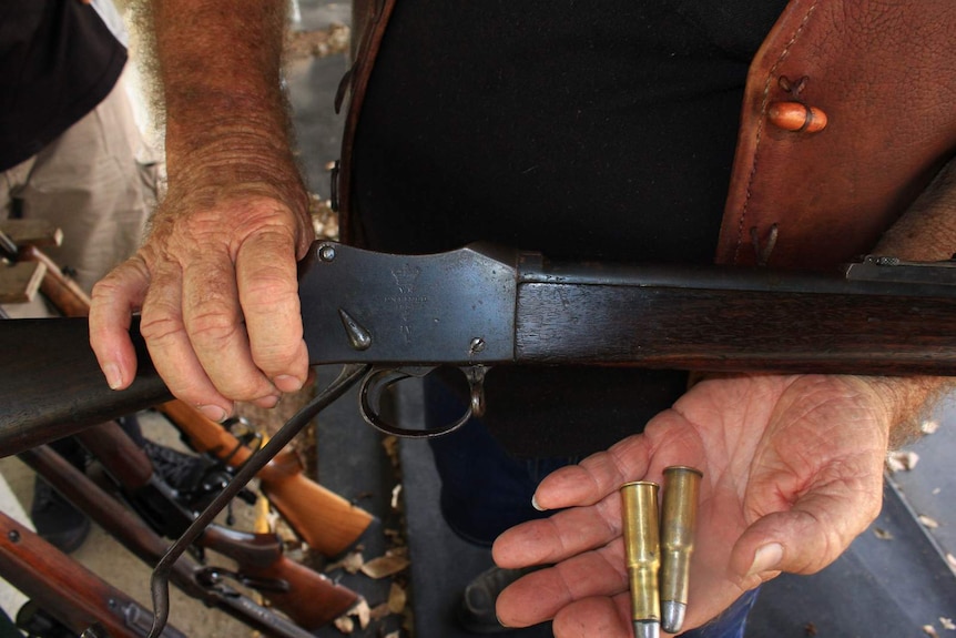 Ted Rodgers holding a rifle dating back to 1887