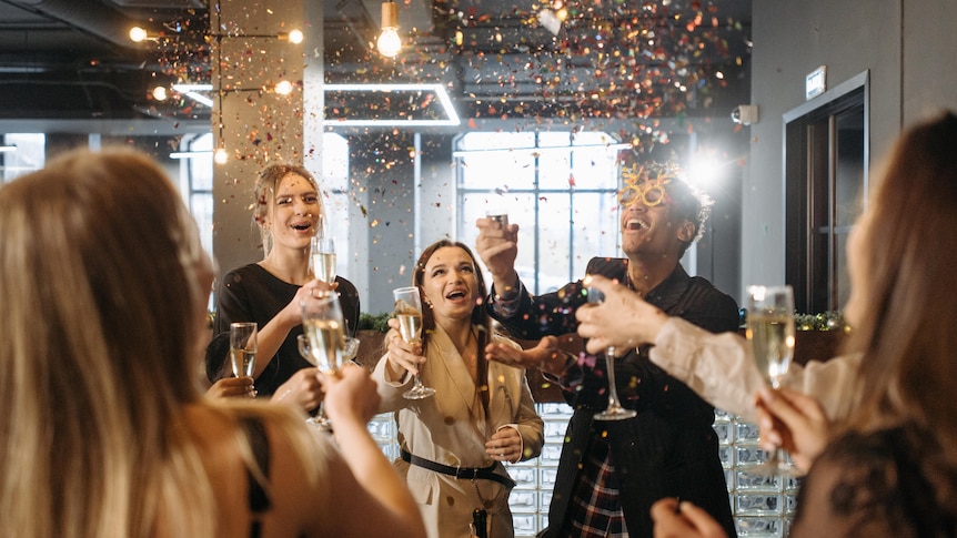 People raising their glasses at a party