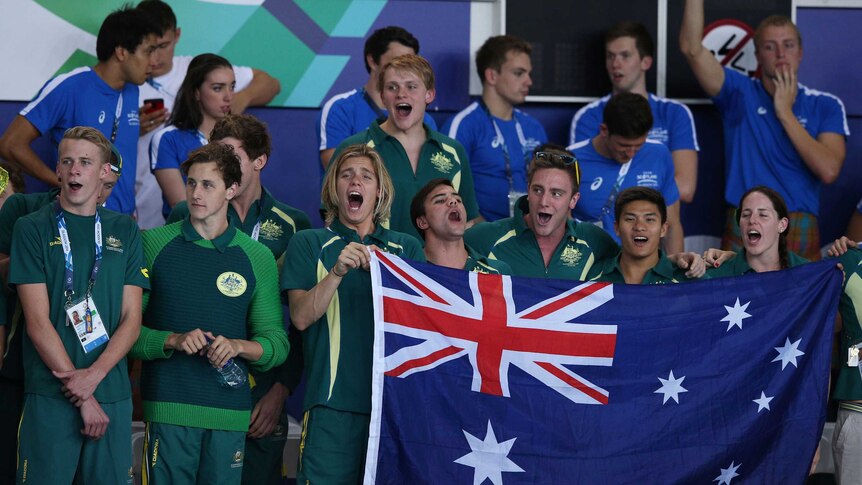 Australian swimming team cheering poolside