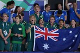 Australian swimming team cheering poolside