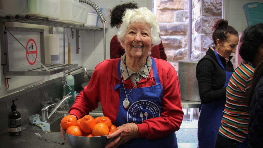 Sister Sheelah Mary holding a bowl of oranges.