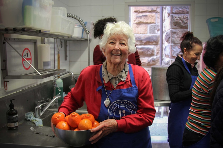 Sister Sheelah Mary holding a bowl of oranges.