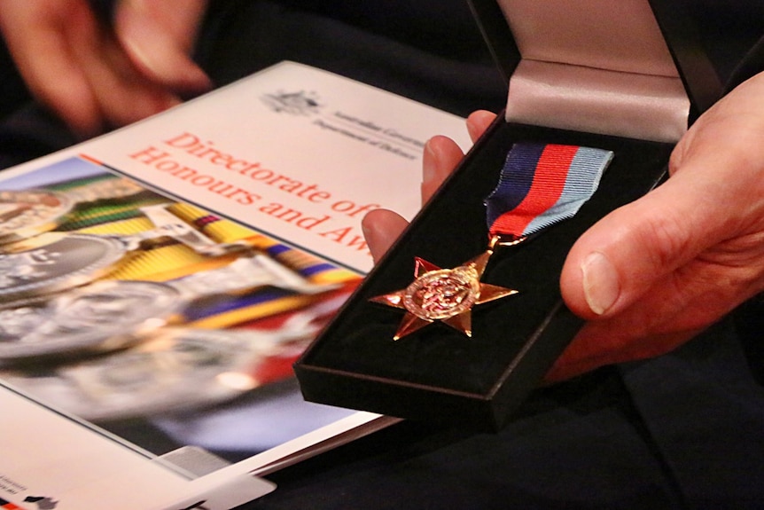 A close-up photograph of a service medal.
