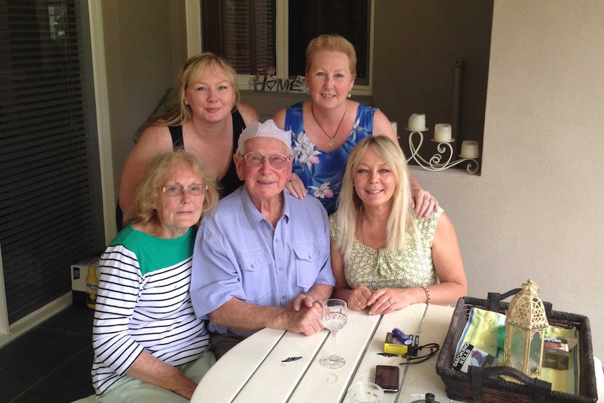 Family of three women surrounding their elderly mother and father.