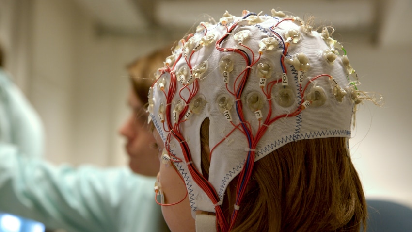 A girl connected with cables for EEG for a scientific experiment.