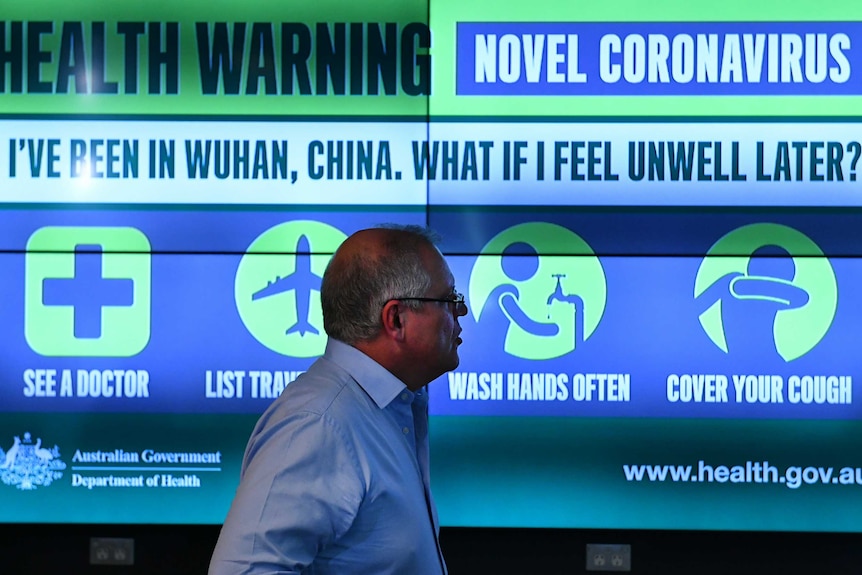 the Prime Minister looking at a health warning screen.