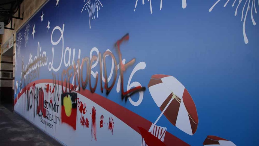 An Australia Day defaced with the words Invasion Day. No Pride in Genocide