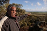 a man points toward trees in the West Australian Wheatbelt