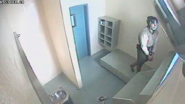 CCTV of 17-year-old handcuffed and wearing spit mask in cell in Brisbane Correctional Centre at Wacol in 2013.