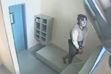 CCTV of 17-year-old handcuffed and wearing spit mask in cell in Brisbane Correctional Centre at Wacol in 2013.