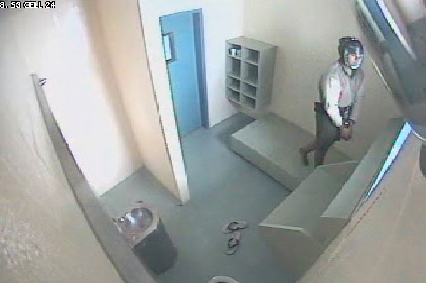 CCTV of 17-year-old handcuffed and wearing spit mask in cell in Brisbane Correctional Centre at Wacol in 2013.