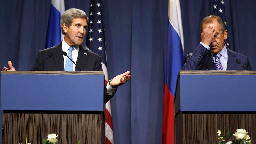 John Kerry gestures as Sergei Lavrov puts his hand on his face