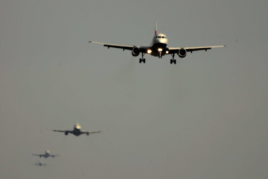 Planes line up, waiting to land at Heathrow Airport