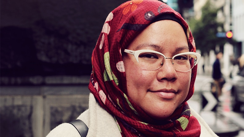 A woman in a headscarf and glasses