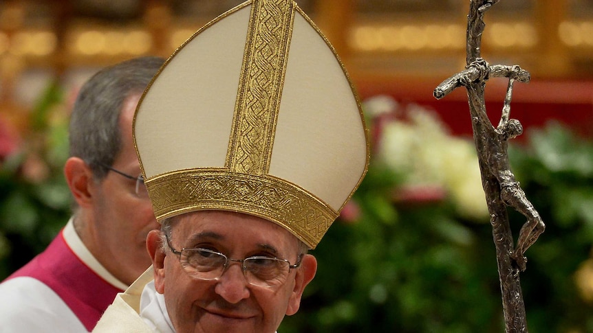 Pope Francis waves on December 12, 2014 in St. Peter's basilica at the Vatican.