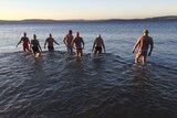 Cold water swimmers enter the water.