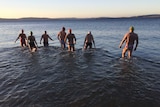Cold water swimmers enter the water.