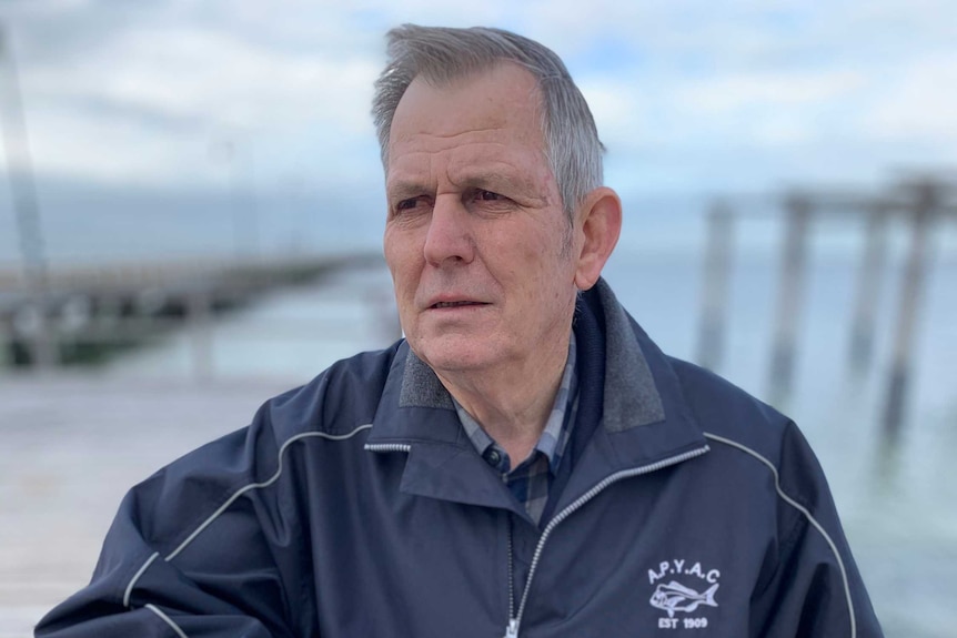 Bob Pearce standing with a jetty in the background.