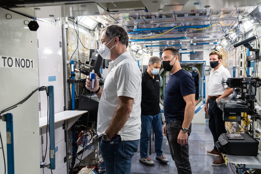 Four men in spacecraft simulator