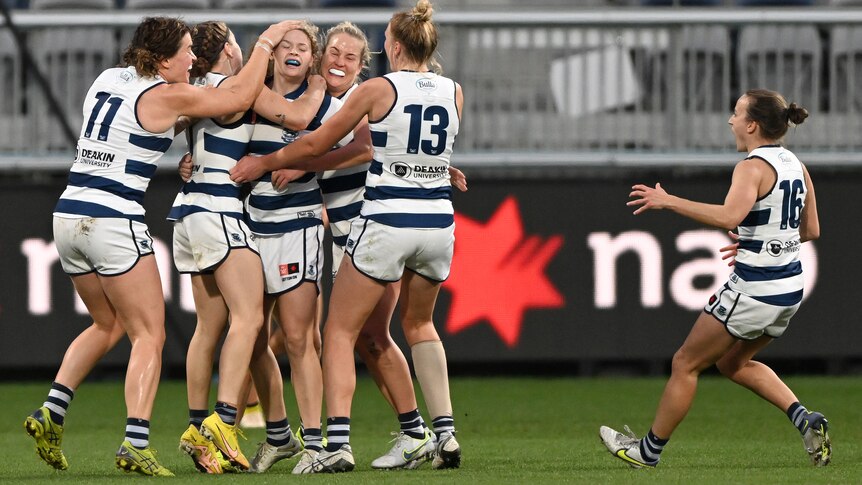 A group of Geelong players swarm around Georgie Prespakis to celebrate with her