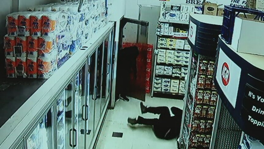 A still from CCTV footage of two men attempting to rob a Tuggeranong IGA