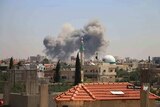 Smoke rising over buildings that were hit by Syrian government forces bombardment in Daraa