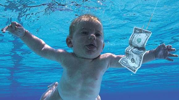 The iconic album cover of the baby in the pool chasing the dollar bill on a fishhook