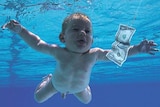 The iconic album cover of the baby in the pool chasing the dollar bill on a fishhook