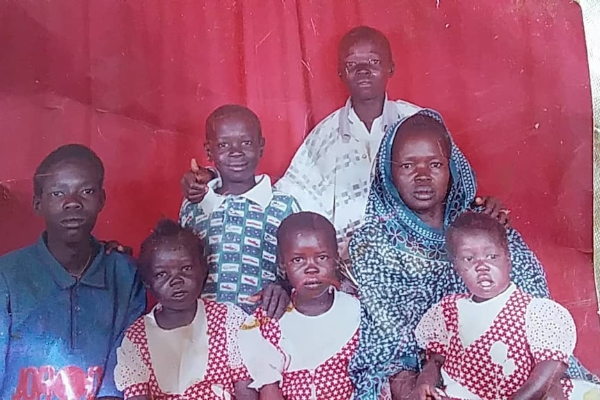 The Chol family smiles for a photo