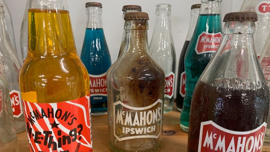 A collection of brightly coloured soft drink bottles.