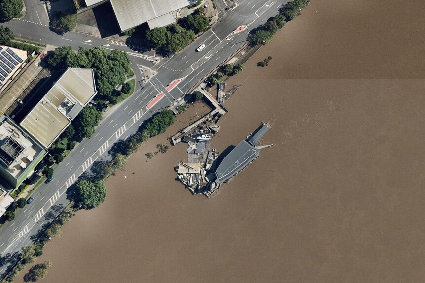 A ferry terminal and floating debris are seen from above.