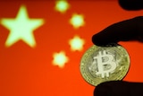 Representation of the Bitcoin cryptocurrency is seen with Chinese flag in the background.