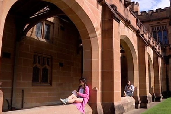 two young female students sitting and reading