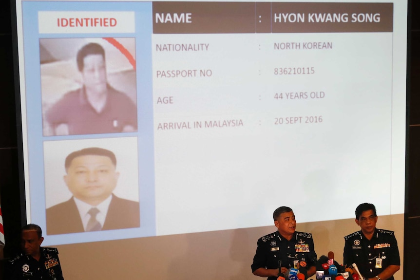 Police display a picture of suspect Hyon Kwang Song on a projector.