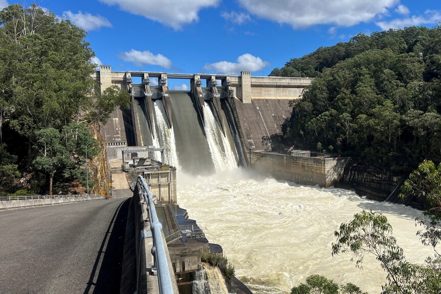 water spilling out of warragamba dam after it reached full capacity due to the severe rainfall