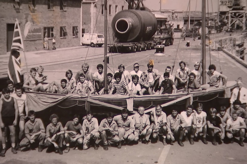 Black and white historical photograph of boat building apprentices in Sydney