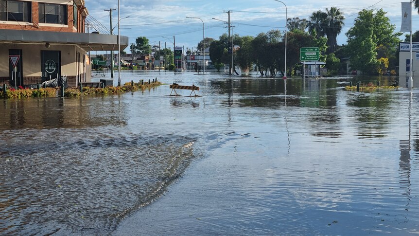 water covers roads and arpound buiding in a street