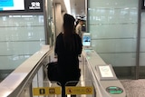 A passenger goes through the facial recognition check-in system