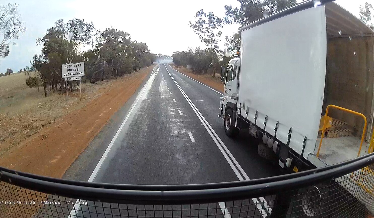 A screenshot from Murray York's dashcam of a truck overtaking across double-white lines.