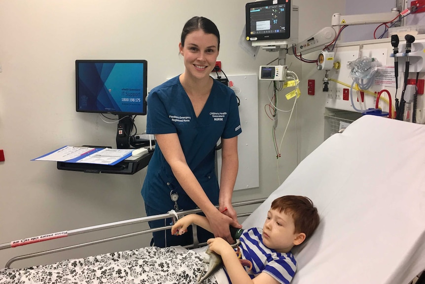 Farron Sullivan working with a child in the Lady Cilento emergency department