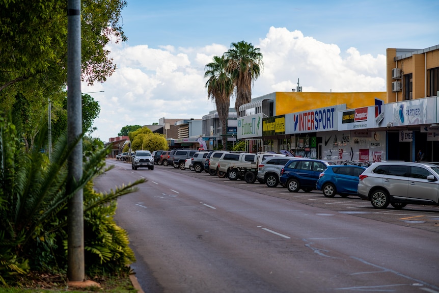 An empty street in Katherine shows just one car driving on the road.