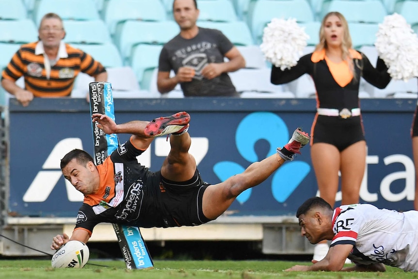 Corey Thompson of Wests Tigers scores against Sydney Roosters in round one, 2018.