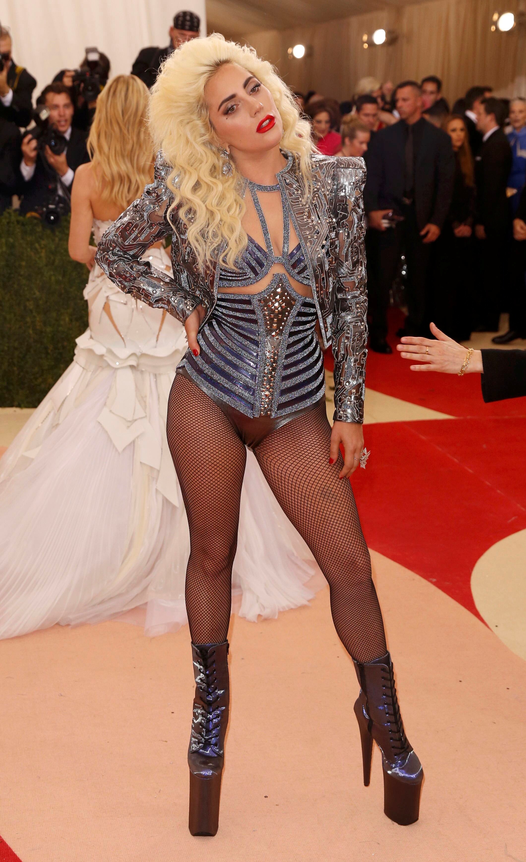 Lady Gaga wearing big silver platform heels and a metallic long-sleeved bodysuit