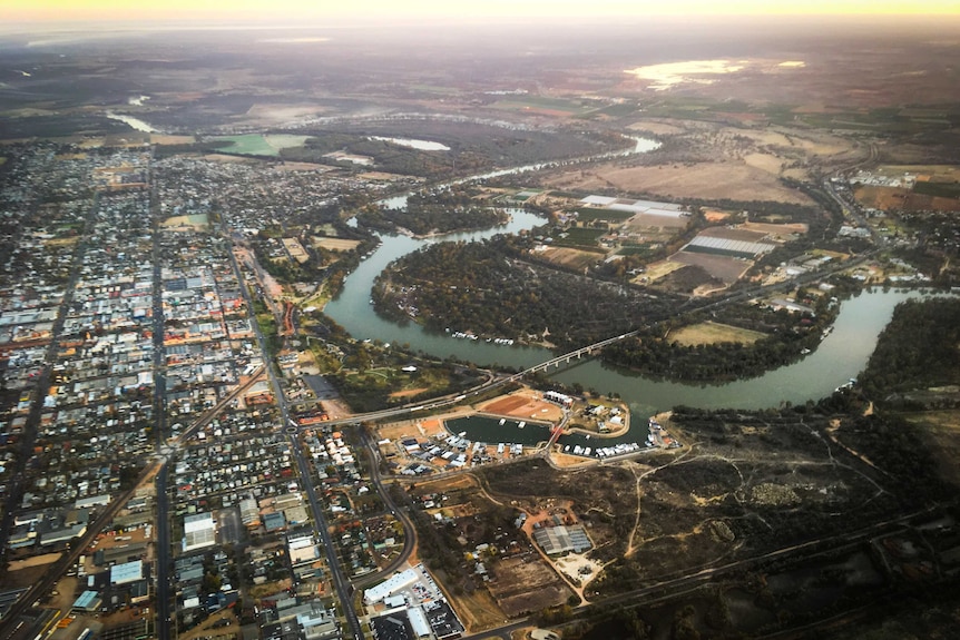 an aerial view of a city with a river running through it 