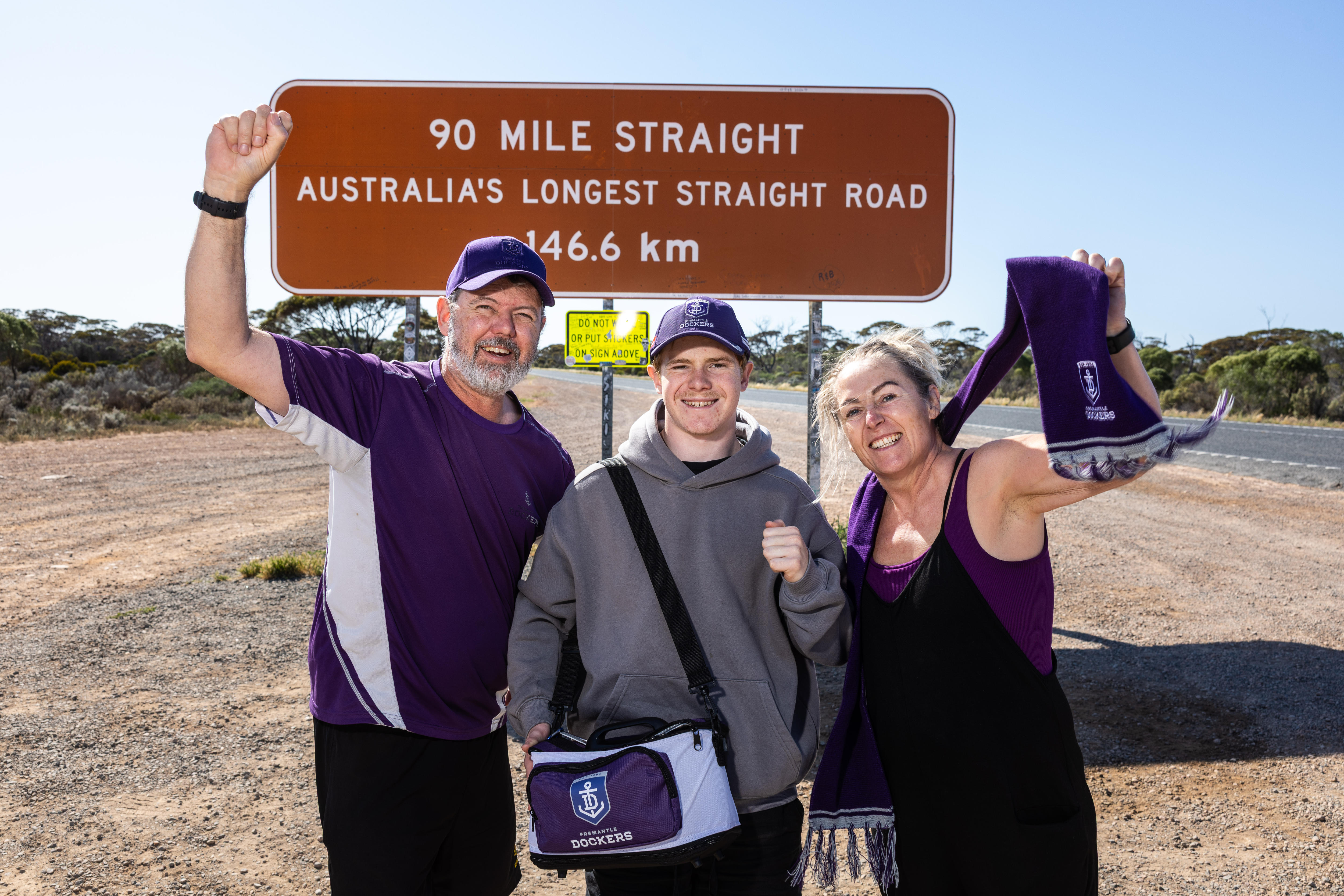 A family of three in Fremantle colours on the Nullarbor