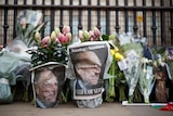 A picture of Britain's Prince Philip, husband of Queen Elizabeth, is seen in the newspapers wrapped around flowers.